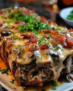 a close up of a plate of food with meat and cheese covered in gravy