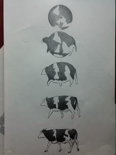 four cows are depicted in black and white on a piece of paper that is taped to the wall