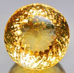 The incredible round cut of this gemstone creates a dazzling display accented by its strong underlying flashing that echos its lively golden yellow hue. It is well cut, measuring a staggering 21.2mm x 16.2mm, and is unheated. Sourced from Brazil. Mineral Jewelry, It Is Well, Gems Jewelry, Golden Yellow, Gemstone Healing, Birthstone Jewelry, Eden, Citrine, Round Cut