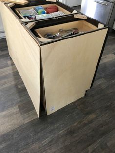 an open cabinet in the middle of a kitchen