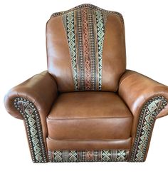 a brown leather chair with an intricately decorated armrest