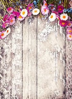 an old wooden background with pink and white flowers on the bottom half of the frame