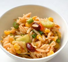 a white bowl filled with pasta and vegetables