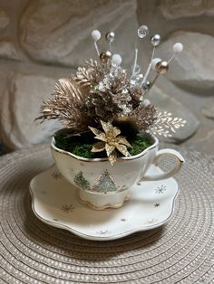 a tea cup with some plants in it