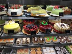 a display case filled with lots of different types of cakes