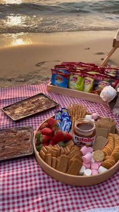 a picnic on the beach with food and snacks