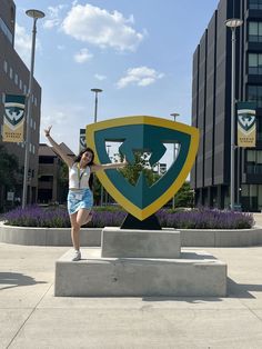 A future Warrior standing in front of the W shield smiling with both hands up in the air. Class Of 2027, Wayne State University, Wayne State, Photo Of The Day, Knit Fashion, State University, The Day, University