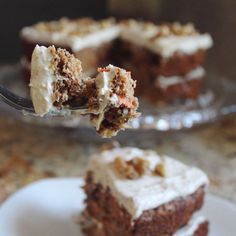 a piece of carrot cake being lifted with a fork