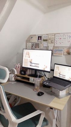 two computer monitors sitting on top of a desk