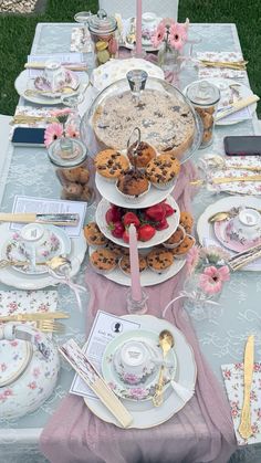 a table set up with plates and desserts