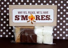 there is a bag of marshmallows in front of a sign that says, why yes, please, we'll have smores