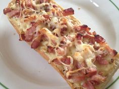 two slices of pizza sitting on top of a white plate