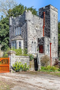 an old castle like building with a gate in front