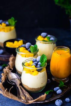 three desserts with blueberries and orange juice on a plate next to each other