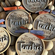 some wooden ornaments with words on them and ribbon around the strings that say teacher appreciation