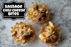 three sausage and cheese bites sitting on top of a marble counter with the words sausage and cheese bites above them