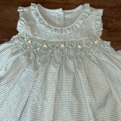 New W/Tags Smocked Green Check Dress, Size 12-18 Months. Good Condition Sleeveless Ruffled Smocked Dress For Playtime, Sleeveless Smocked Dress With Ruffles For Playtime, White Cotton Smocked Dress With Ruffle Hem, White Smocked Dress For Playtime, White Smocked Bodice Dress For Playtime, White Short Sleeve Smocked Dress For Playtime, White Playtime Dress With Smocked Cuffs, Sleeveless Smocked Dress For Playtime, Sleeveless Smocked Dress With Smocked Back For Playtime