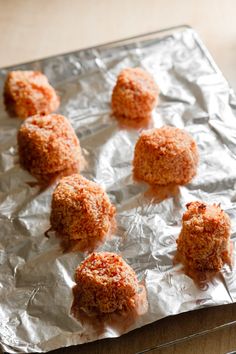 some food is sitting on top of tin foil and ready to be cooked in the oven