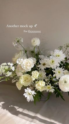 a vase filled with white flowers on top of a table