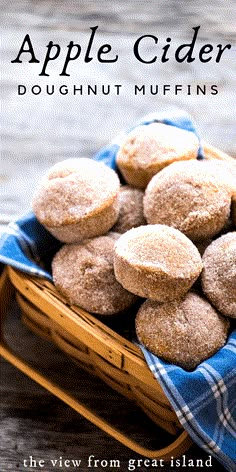 a basket full of doughnut muffins sitting on top of a blue towel