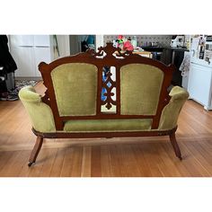 an old fashioned couch sitting on top of a hard wood floor