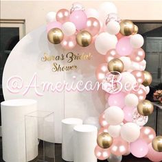 an american bee balloon arch with pink, white and gold balloons