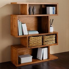 a wooden shelf with baskets and books on it