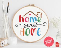 a cross stitch pattern with the words home sweet home on it next to some crafting supplies