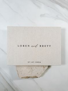 a close up of a piece of paper on top of a marble slab with the words, loren and breit