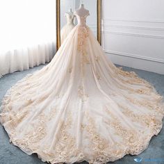 a wedding dress is displayed in front of a mirror