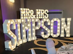 a large marquee sign that says mr and mrs simpson on the side of a room