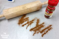 a wooden rolling pin next to some cinnamon powder and a bottle of marmalade