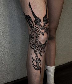 a woman's leg with tattoos on it and a tattoo design on the side