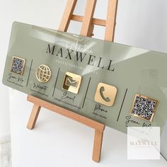 a wooden easel with five different types of cell phones on it's display