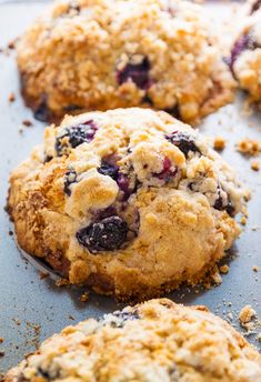 blueberry oatmeal breakfast cookies on a baking sheet with crumbs