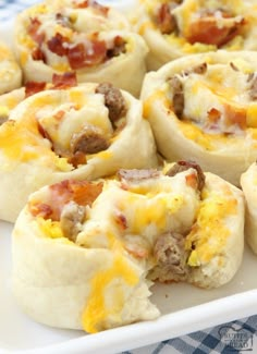 breakfast rolls on a white plate with blue and white checkered table cloth