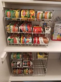 an organized pantry with canned food in the bottom shelf and other items on the bottom shelf