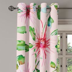 pink and green floral curtains hanging in front of a window