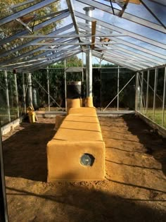 the inside of a small greenhouse with some dirt on the ground and plants growing in it