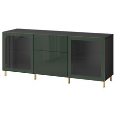 a green cabinet with two doors and gold legs