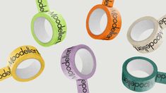 four rolls of tape with the words made in different colors and sizes on each side