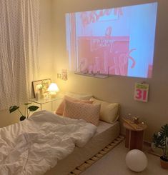 a bed with white sheets and pillows next to a window covered in pink light curtains