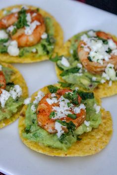 four shrimp and guacamole on corn tortillas