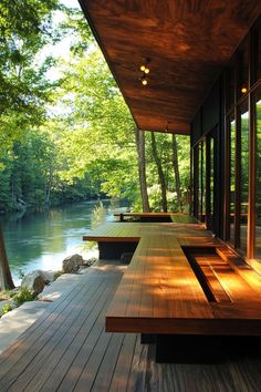 a wooden deck with benches next to a river