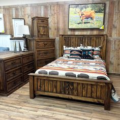 a bed room with a neatly made bed and dressers on each side of the bed