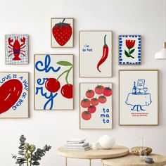 there are many different pictures on the wall in this room, including tomatoes and peppers