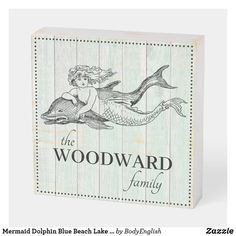 a wooden block with an image of a mermaid and the words woodward family on it