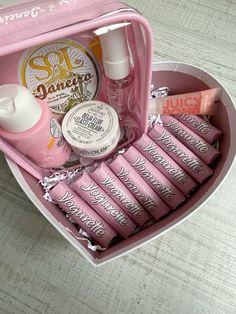 a pink heart shaped box filled with lots of beauty products