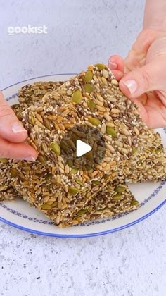 two hands reaching for granola on a plate