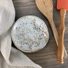 two wooden spoons and a plate on a table